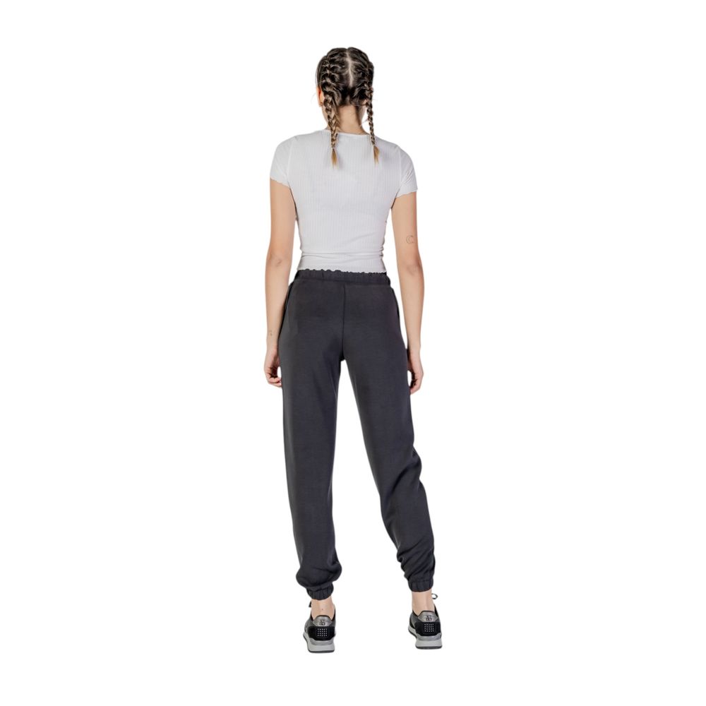 Guess Active black polyester joggers for workout, featuring a tapered fit and elastic waistband, suitable for activewear and casual wear.