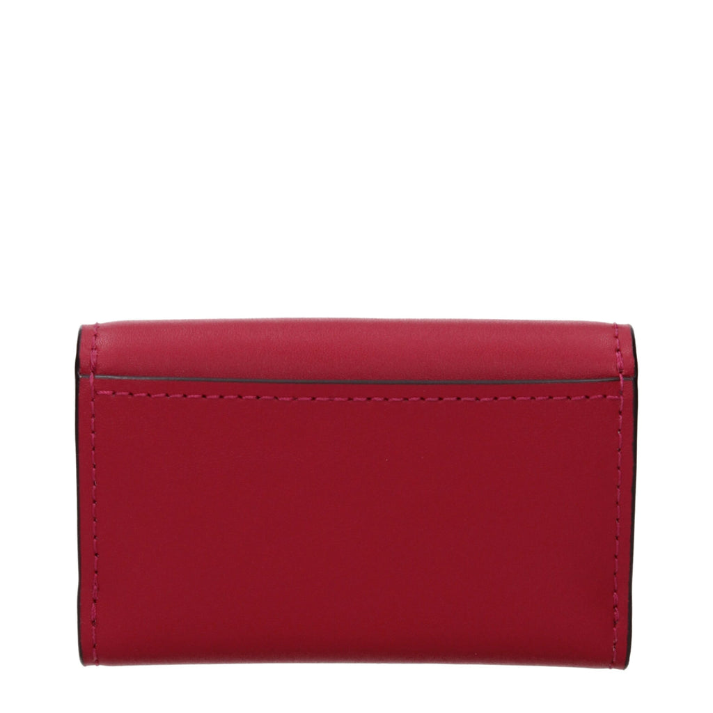 Red leather Michael Kors wallet with multiple card slots and a sleek design, featuring the brand logo and zipper closure.