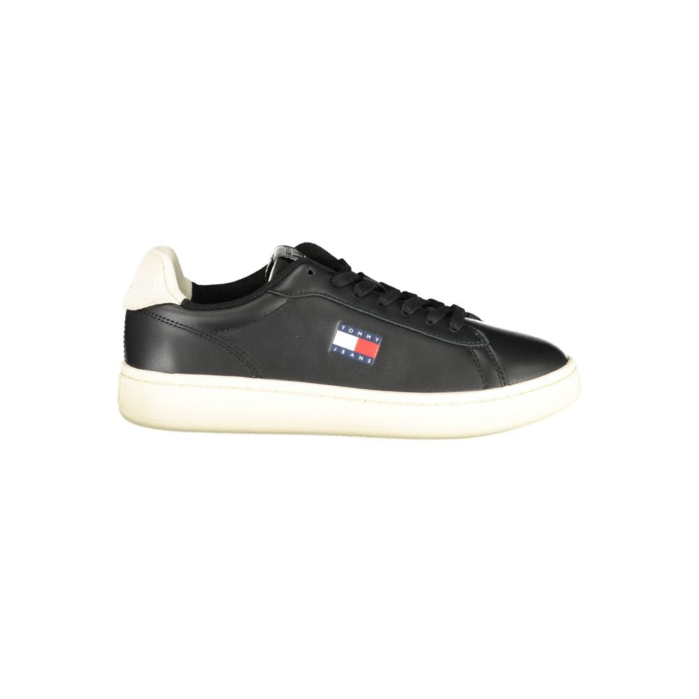 Black Tommy Hilfiger women's sneaker with polyurethane upper, stylish design, and white sole.