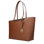 Michael Kors brown leather shoulder bag with gold-tone hardware, featuring adjustable strap and spacious interior.