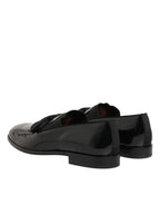 Black leather slip-on loafers for men by Dolce & Gabbana, featuring a sleek design and classic style.