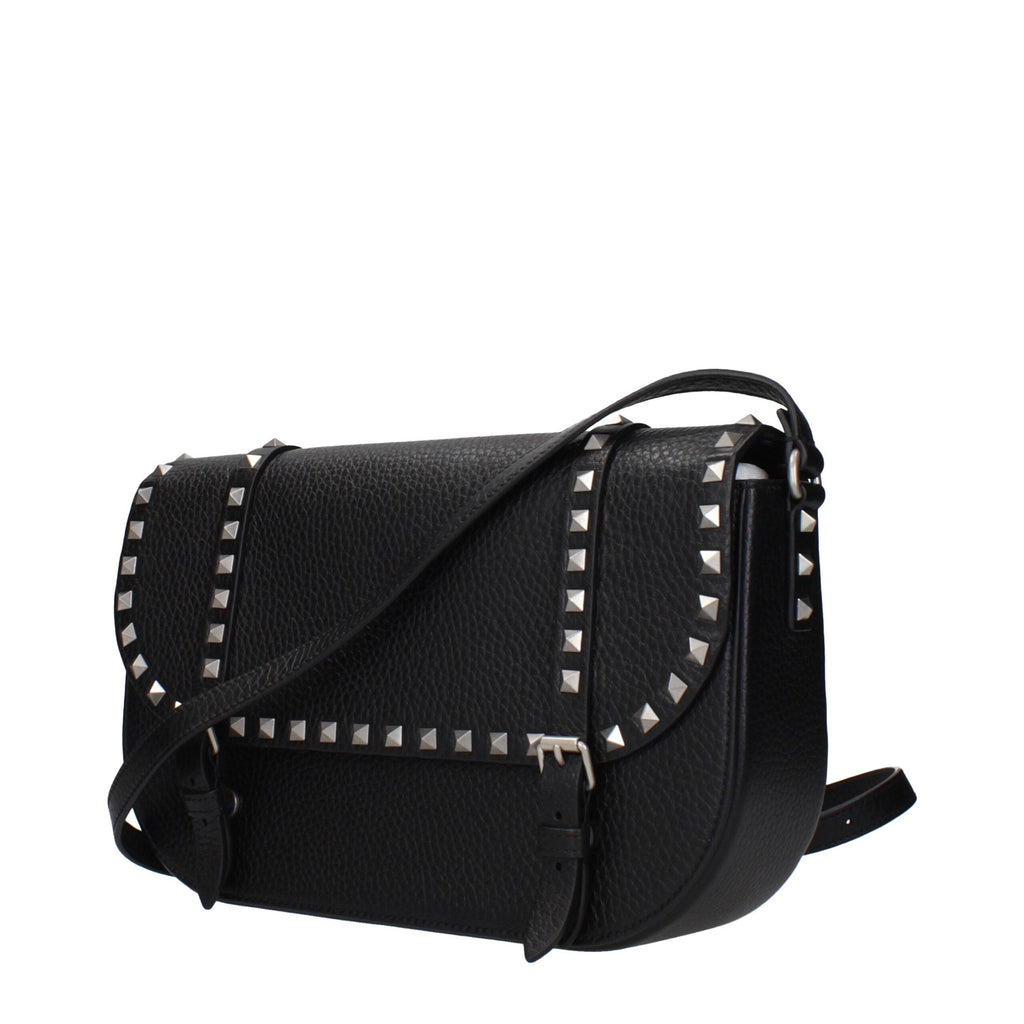 Black leather Valentino Garavani crossbody bag with silver hardware and adjustable strap, showcasing sleek, elegant design.