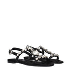 Black satin flat sandals by Dolce & Gabbana with sleek design and open toes, perfect for elegant summer footwear.