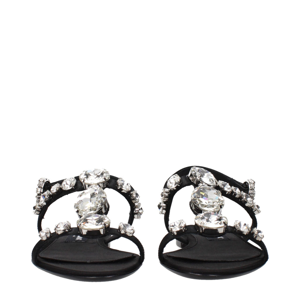 Black satin flat sandals by Dolce & Gabbana with sleek design and open toe, perfect for elegant summer footwear.