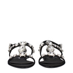 Black satin flat sandals by Dolce & Gabbana with sleek design and open toe, perfect for elegant summer footwear.