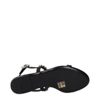 Black satin flat sandals by Dolce & Gabbana with sleek straps and elegant design.