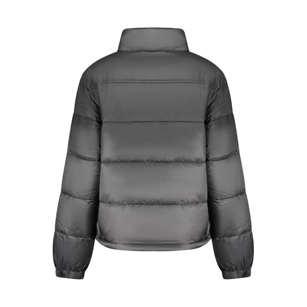 Black Tommy Hilfiger women's polyester jacket with a sleek design and front zipper, casual outerwear for everyday wear.