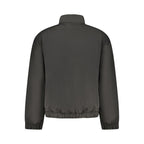 Black polyester men's jacket by Tommy Hilfiger, shown with front zipper, collar, and sleek design for casual or outdoor wear.