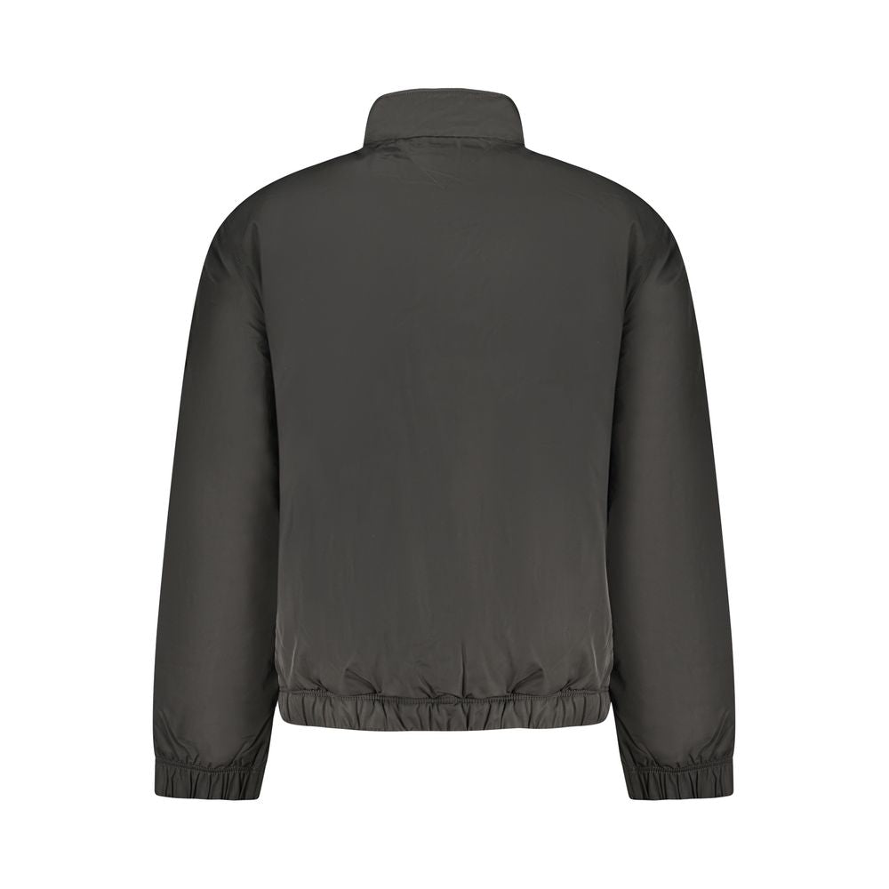 Black polyester men's jacket by Tommy Hilfiger, shown with front zipper, collar, and sleek design for casual or outdoor wear.
