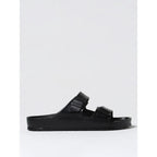 Black EVA flat sandals by Birkenstock with adjustable strap and open toe design, suitable for casual wear.