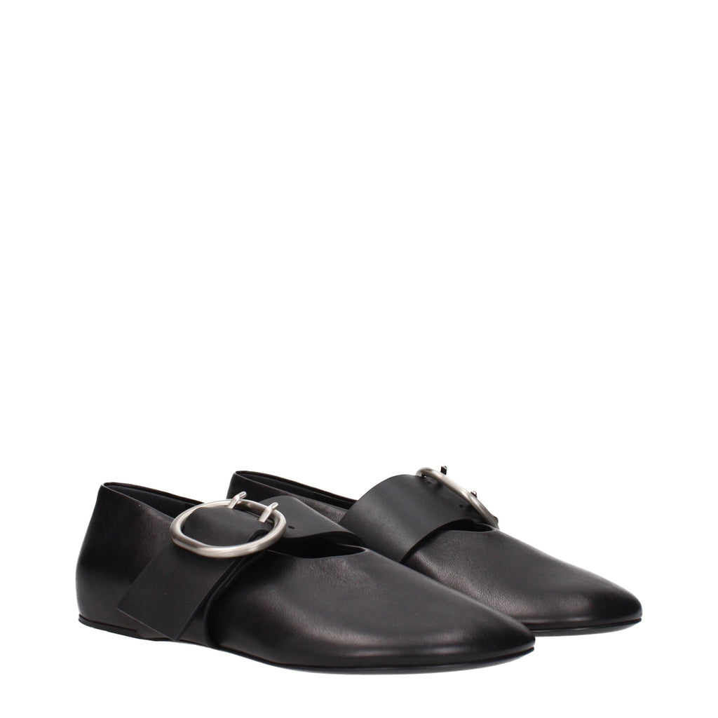 Black leather ballet flats by Jil Sander, featuring a sleek, minimal design and pointed toe, shown on a neutral background.