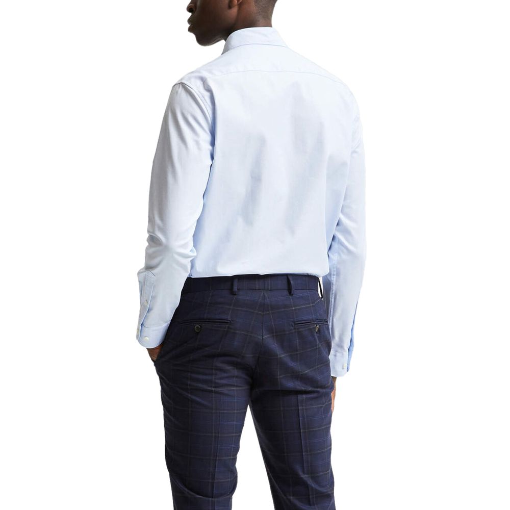 Selected blue cotton dress shirt with a classic collar and button-down front, displayed on a hanger.