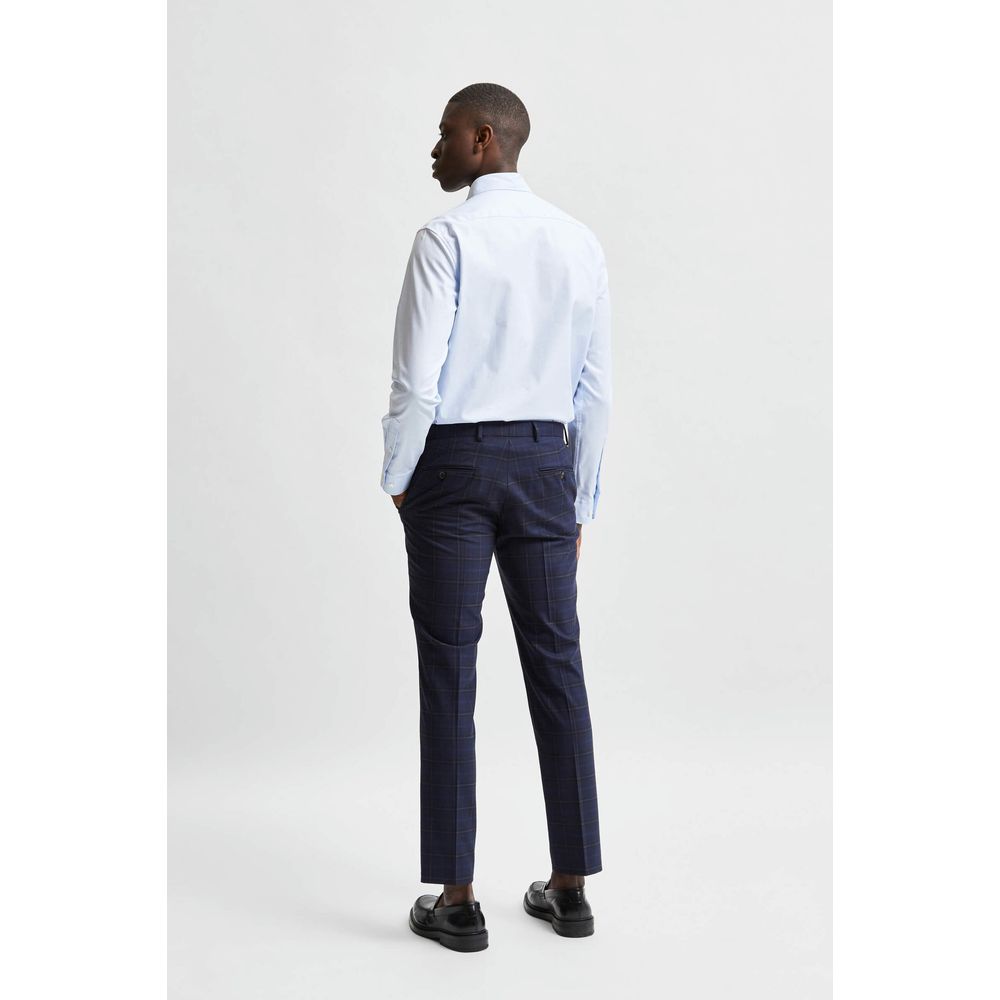 Selected blue cotton dress shirt with collar and long sleeves, neatly pressed and displayed on a hanger.