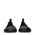 Black leather ballet flats by The Attico, featuring a sleek, classic design with a rounded toe and smooth finish.