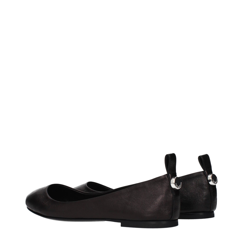Black leather ballet flats by The Attico with a sleek, rounded toe and minimalist design on a plain background.