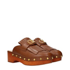 Valentino Garavani brown leather slippers with sleek design and comfortable slip-on style.