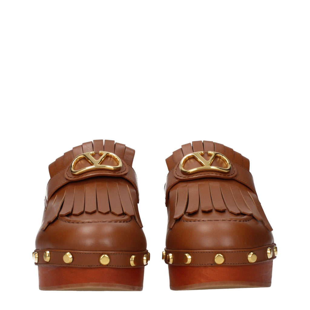 Brown leather slippers by Valentino Garavani with sleek design and subtle branding, perfect for casual or stylish indoor wear.