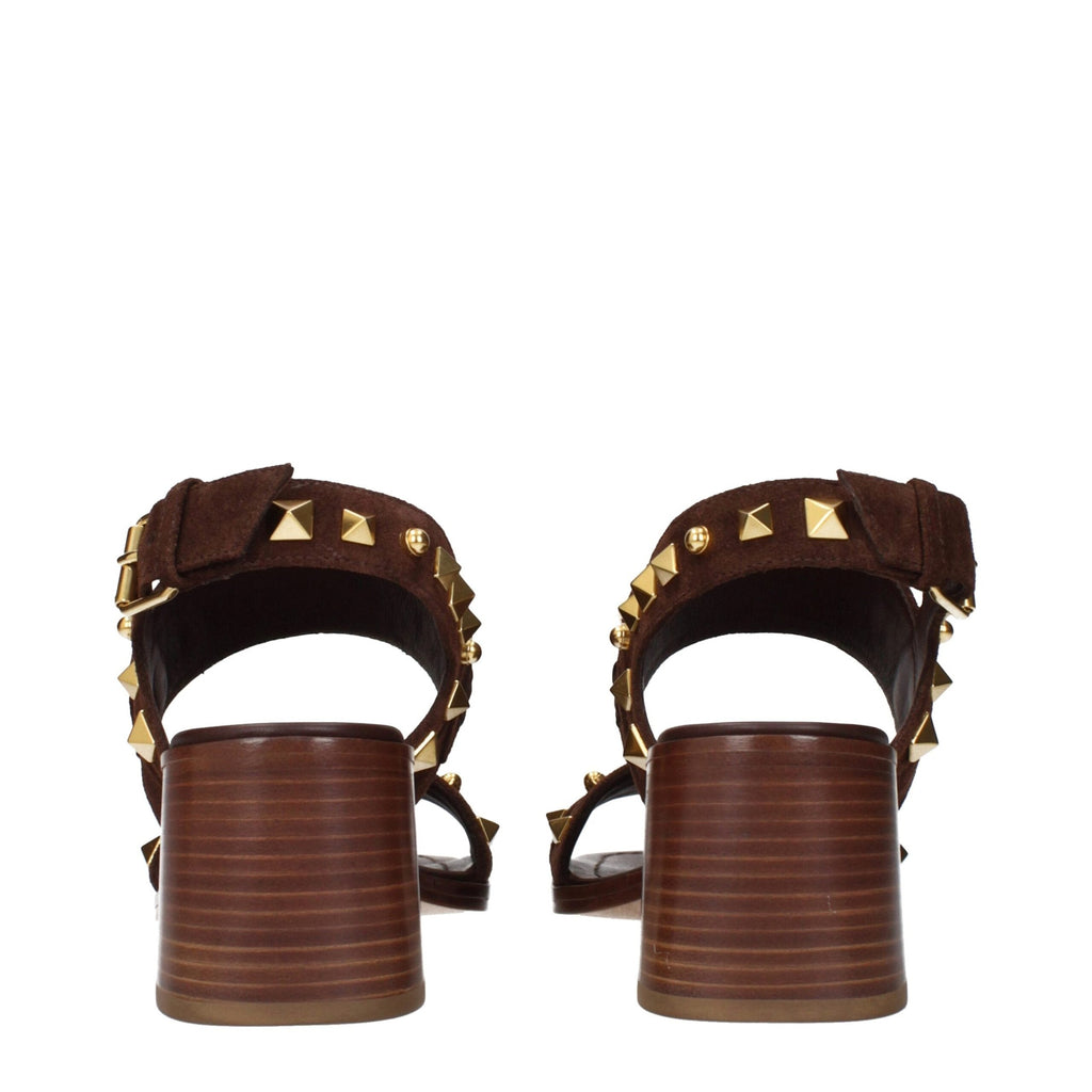 Brown leather strap-on sandals by Valentino Garavani with open toe and ankle strap, stylish and comfortable for warm weather.
