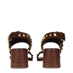 Brown leather strap-on sandals by Valentino Garavani with open toe and ankle strap, stylish and comfortable for warm weather.