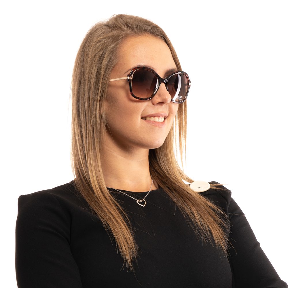 Guess brown metal and plastic sunglasses with rounded frames and tinted lenses, stylish and lightweight for everyday wear.