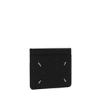 Maison Margiela black calf leather Bos Taurus wallet with sleek design and subtle branding, featuring multiple card slots.