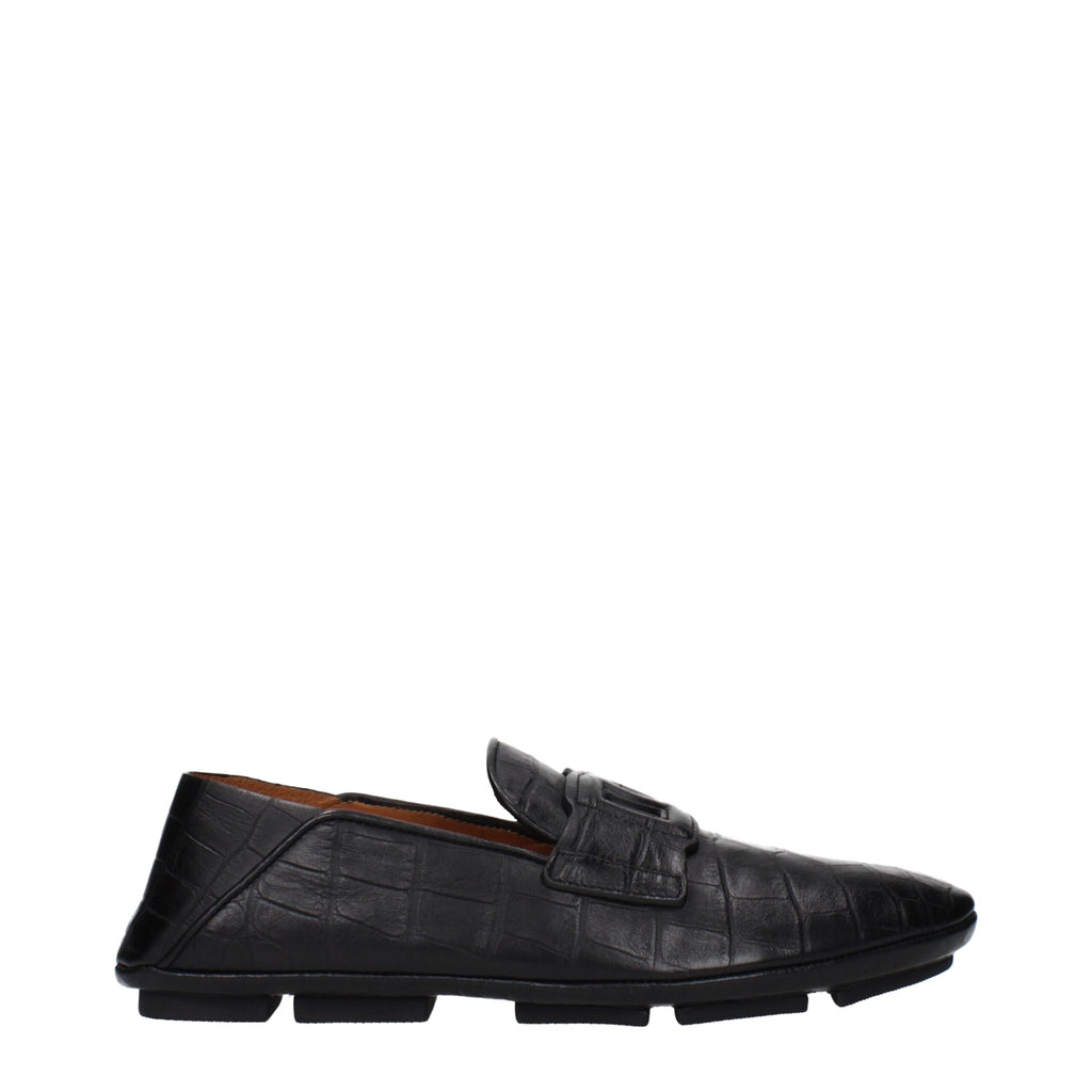 Black leather slip-on loafers by Dolce & Gabbana with sleek design and detailed stitching on a neutral background.