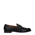 Black leather slip-on loafers by Valentino Garavani with sleek design and polished finish, perfect for stylish casual wear.