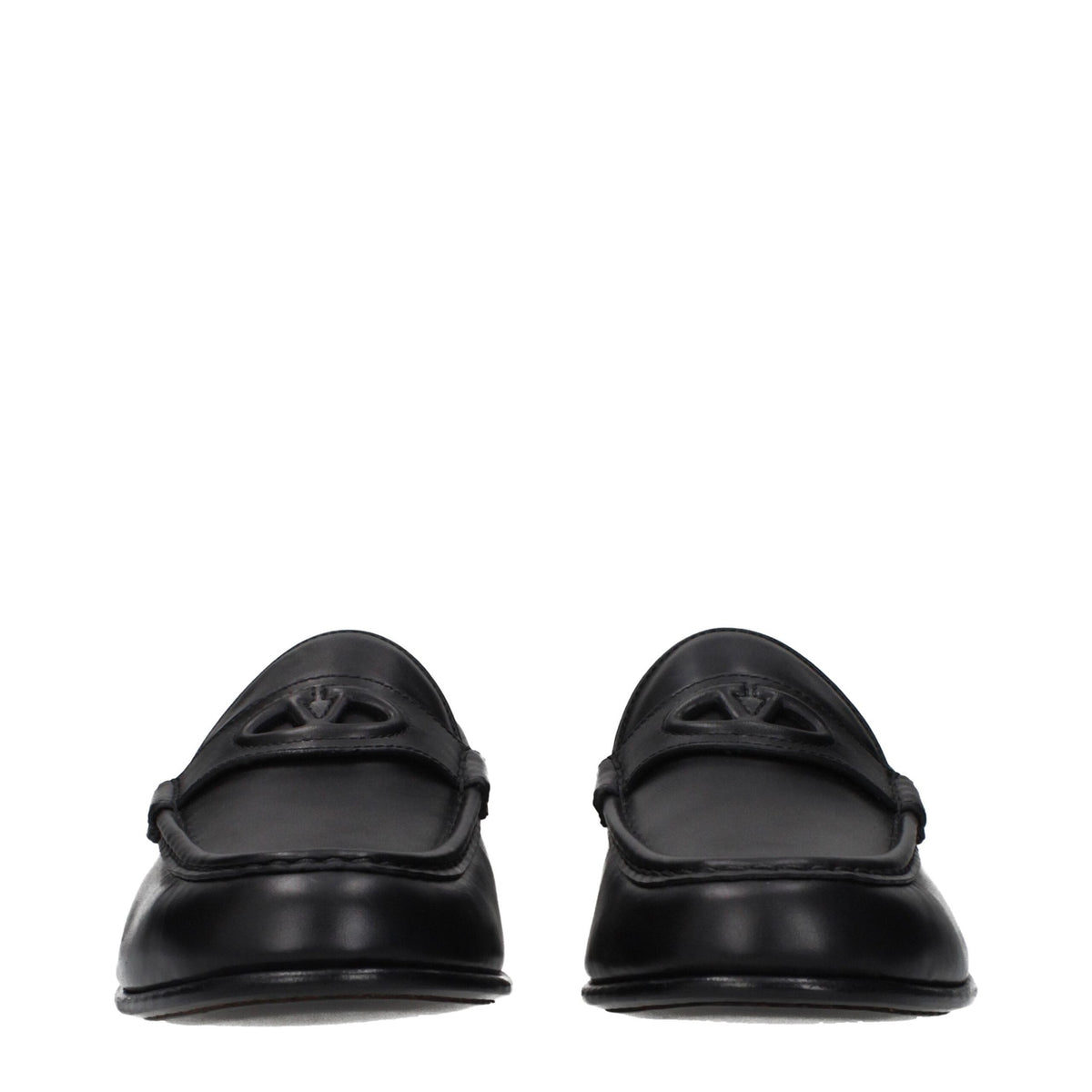 Valentino Garavani black leather slip-on loafers with sleek design and subtle stitching, perfect for stylish casual wear.