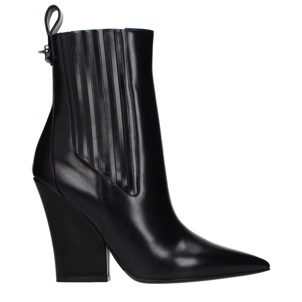Black leather ankle boots by Valentino Garavani with sleek design and pointed toes, stylish footwear for versatile outfits.
