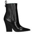 Black leather ankle boots by Valentino Garavani with sleek design and pointed toes, stylish footwear for versatile outfits.