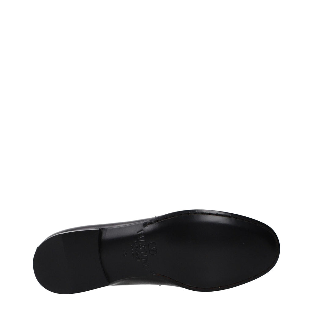 Black leather Valentino Garavani slip-on loafers with sleek design and minimal detailing, perfect for stylish casual or formal wear.