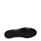 Black leather Valentino Garavani slip-on loafers with sleek design and minimal detailing, perfect for stylish casual or formal wear.