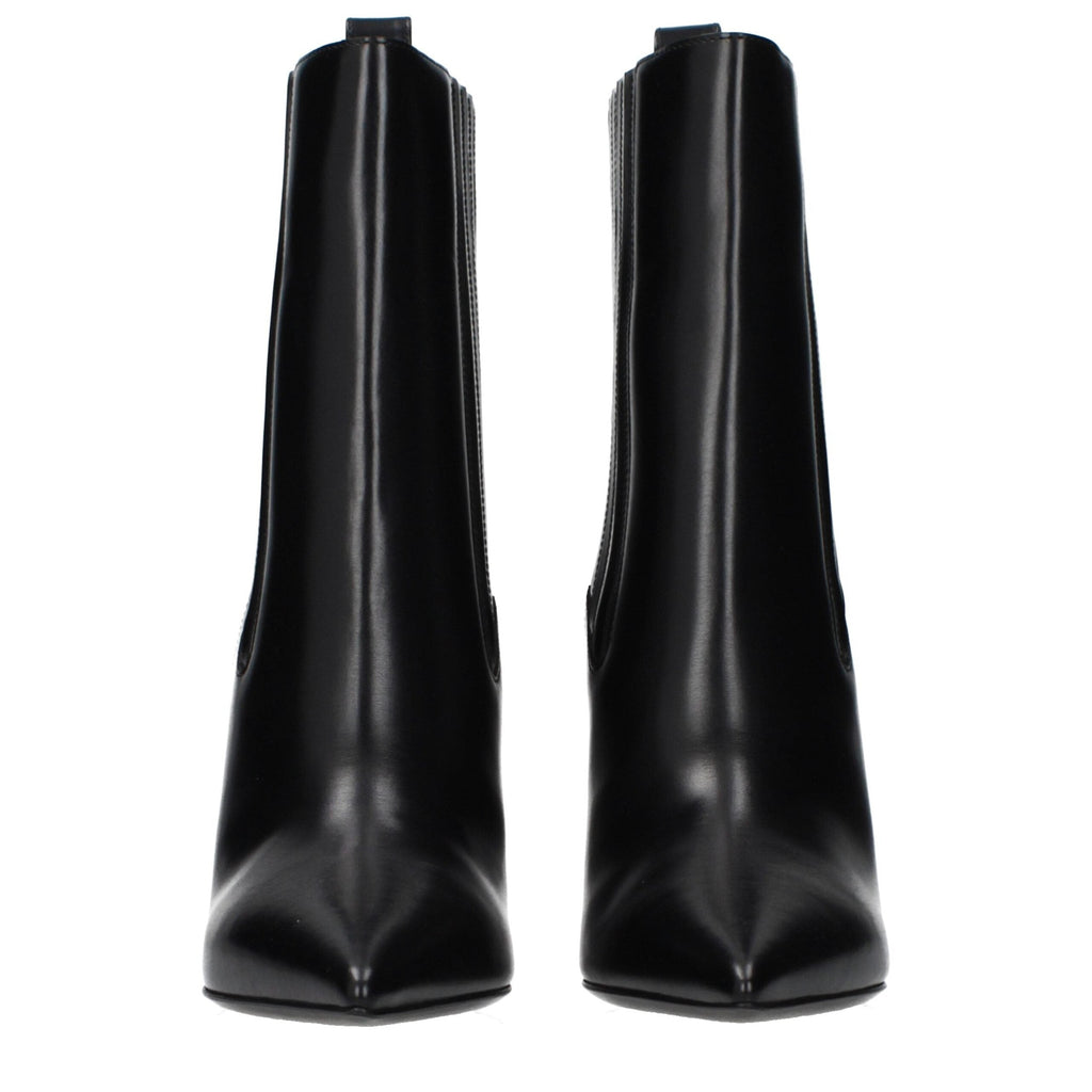 Valentino Garavani black leather ankle boots with sleek design and pointed toes, featuring subtle branding details.