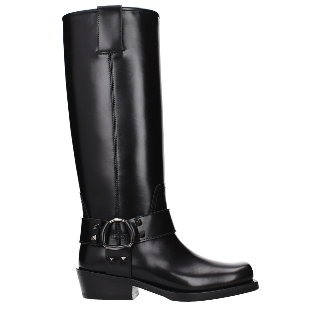 Black leather boots by Valentino Garavani with sleek design, pointed toe, and stylish ankle height.