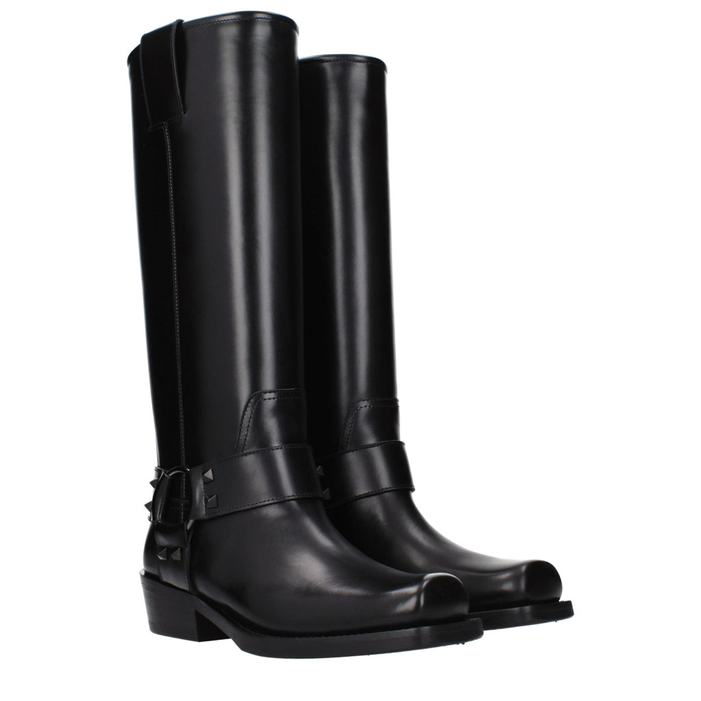 Black leather Valentino Garavani boots with sleek design and pointed toes, stylishly displayed on a neutral background.