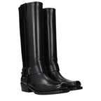 Black leather Valentino Garavani boots with sleek design and pointed toes, stylishly displayed on a neutral background.