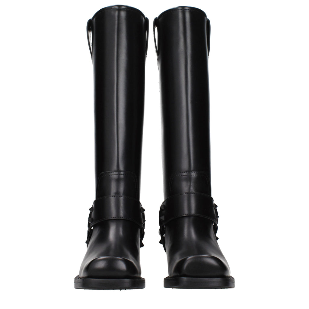 Black leather boots from Valentino Garavani with sleek design and polished finish, featuring pointed toes and ankle-high style.