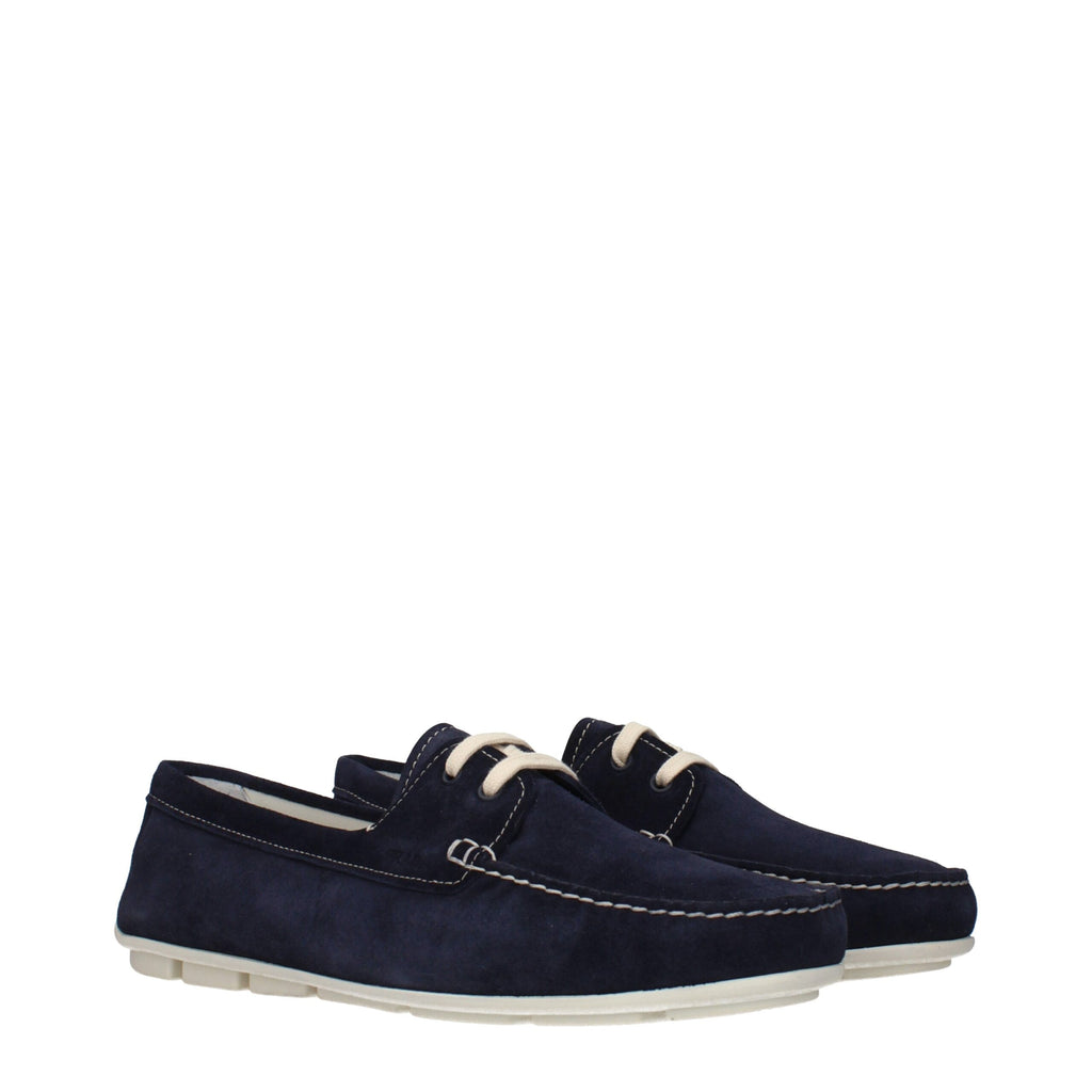 Prada blue leather slip-on loafers with sleek design and stitching details, perfect for stylish and comfortable footwear.