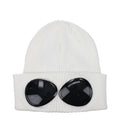 White cotton beanie by C.P. Company, close-up view showing soft fabric and simple, classic knit design.