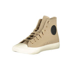 Beige leather Converse unisex sneaker with white rubber sole and classic lace-up design, showing side view and textured material.