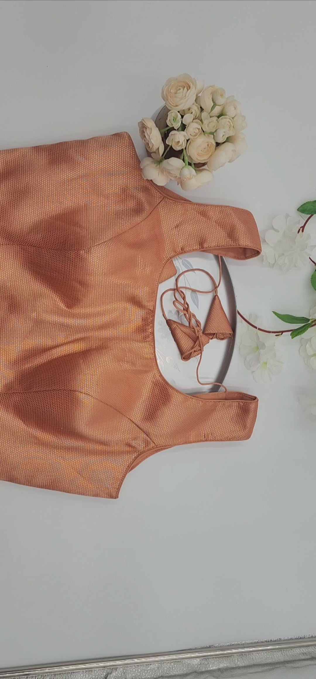 Brocade blouse with embedded floral design in Gold and light red shade  sleeveless Free size